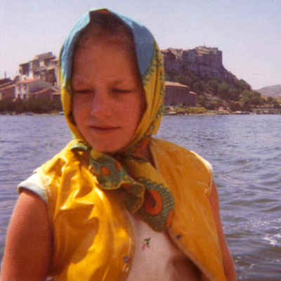 Young Polly in scarf sailing in front of Bages