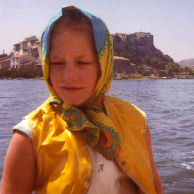 Young Polly in scarf sailing in front of Bages